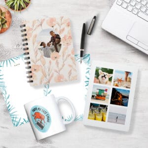 Image of a desktop with personalized stationery, notebooks, and a custom coffee mug. Nearby is a laptop, pen, and houseplants.